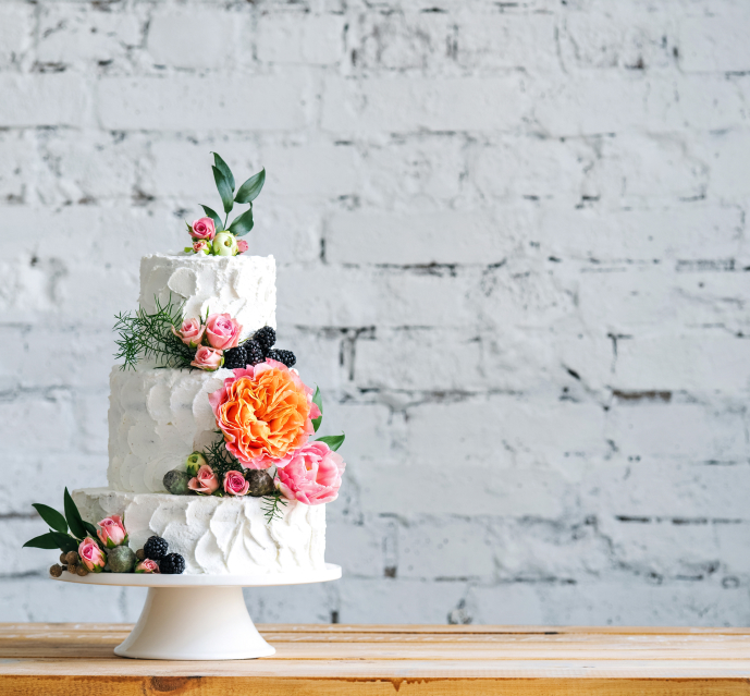 White wedding cake with flower decorations